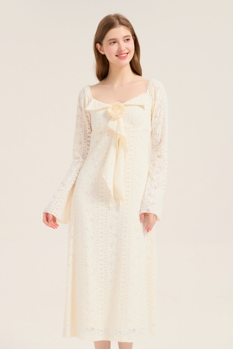 Model smiling in an ivory lace long sleeve midi dress featuring a romantic bow and rose detail, perfect for bridal or garden occasions.