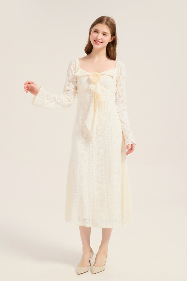 Model smiling in an ivory lace midi dress featuring a large bow with rose detail at the neckline, square collar, and long flared sleeves.
