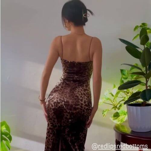Back view of woman wearing a brown leopard print velvet slip dress from Sioéne in soft indoor lighting — modern, sensual party outfit inspiration.