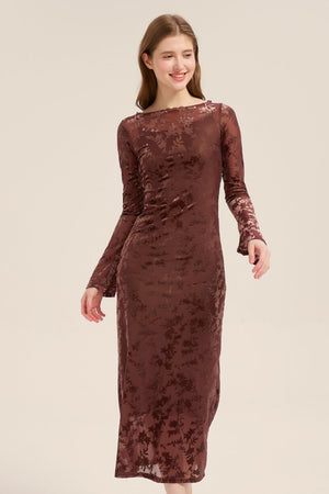 A woman in a mocha floral burnout velvet midi dress with long sleeves and body-skimming silhouette for an elegant evening look.