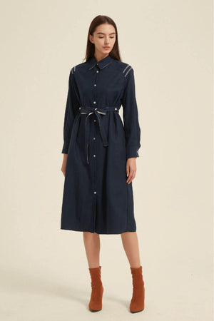 Full front studio shot of a navy button-down midi shirt dress featuring a belted waist and long sleeves — effortless and versatile design for day to night wear.