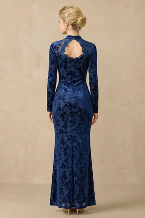 Back view of a navy floral velvet maxi dress showing the open lace-trimmed back neckline, long sleeves, and smooth fitted silhouette.