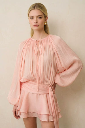 Mid-length view highlighting the gathered waist and cascading chiffon layers of the peach shorts set, paired with statement gold earrings.