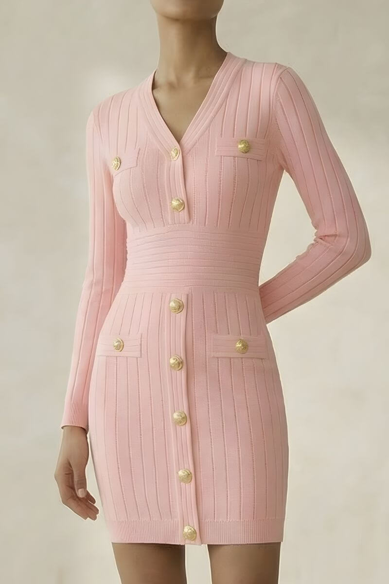 Model wearing a pink ribbed knit mini dress with long sleeves, gold statement buttons, and a fitted waist, photographed against a neutral backdrop.