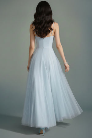 Back view of the powder blue tulle maxi dress showing thin straps, clean back seam, and a softly flowing tulle skirt.