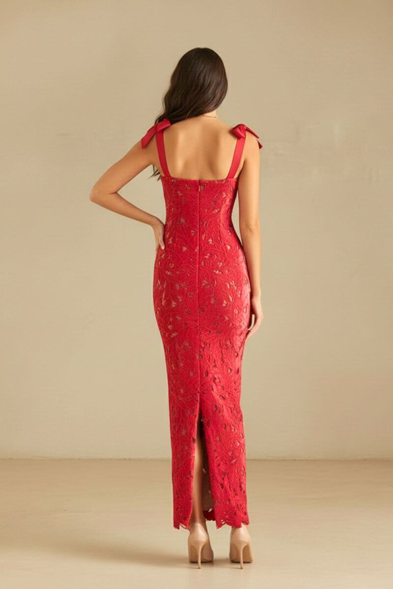 Back view of the red lace dress with bow straps, exposed zipper, and back slit, showing the fitted lace silhouette.