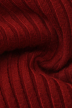 A close-up photo of the red ribbed knit fabric showing the soft, stretchy texture and fine vertical stitching of the sweater.