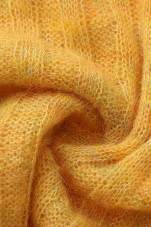 Soft yellow mohair knit fabric shown in a close-up texture shot, highlighting the fuzzy, lightweight, breathable material used for the Sioéne long-sleeve sweater.