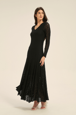 Model wearing black lace long sleeve maxi dress, angled front view highlighting flared skirt and V-neckline.