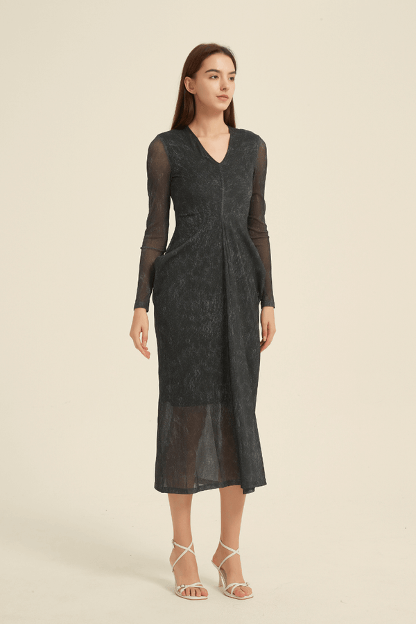 Model wearing a black sheer long sleeve midi dress with V-neckline and flowy silhouette, perfect for evening elegance and formal occasions.