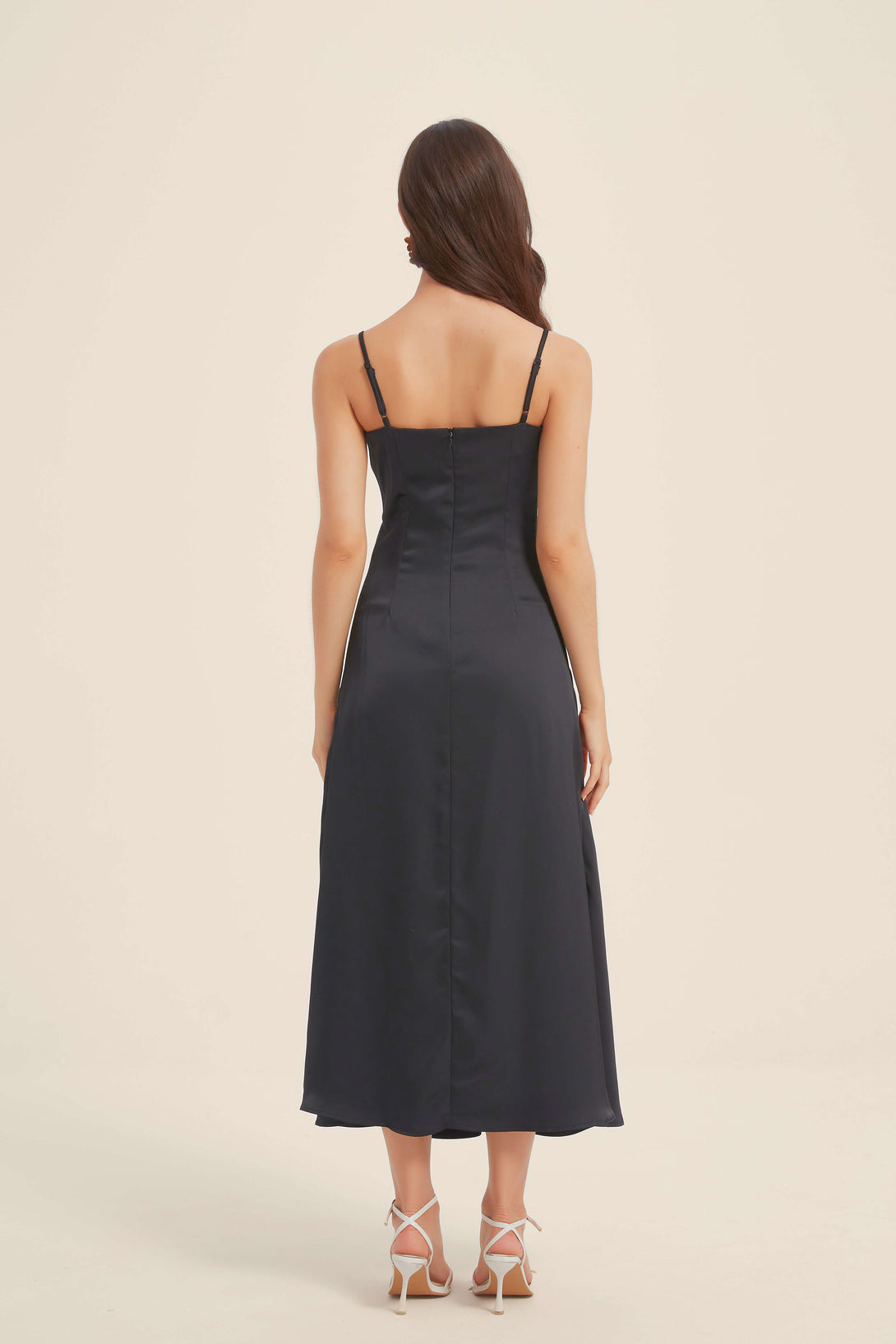 Back view of black satin midi dress with adjustable straps and invisible zip closure