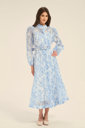 Model wearing a blue floral print midi dress with a belted waist and button-down front.