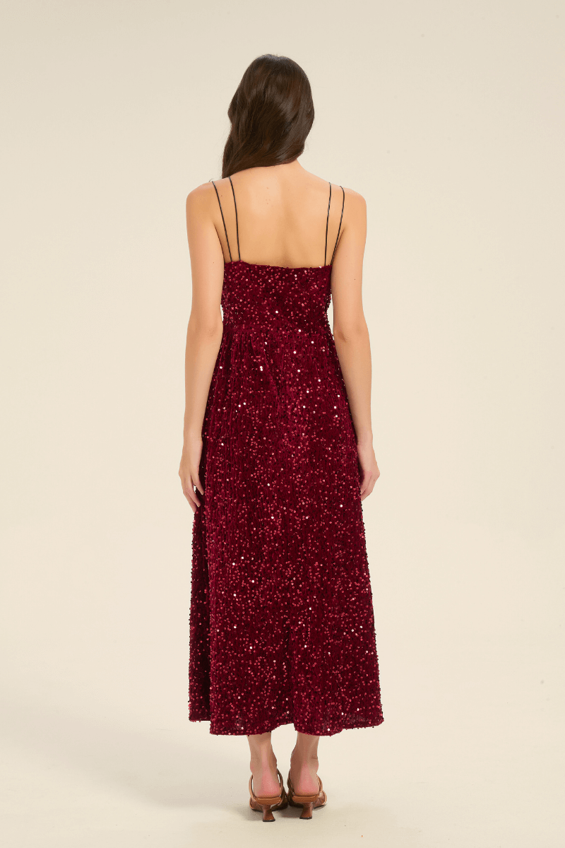 Back view of a burgundy sequin V-neck maxi dress with double spaghetti straps and a straight backline.