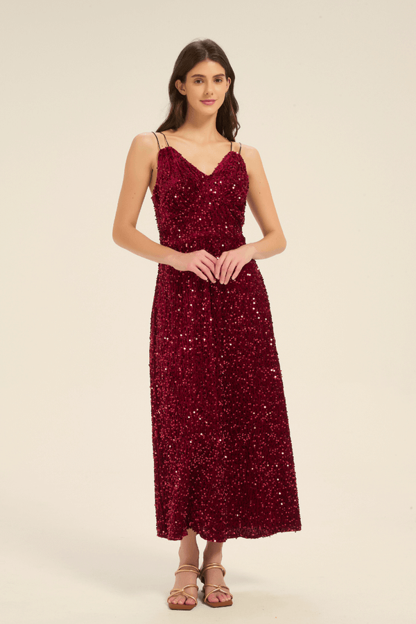 Angled front view of a burgundy sequin maxi dress with double spaghetti straps and shimmering sequin details.