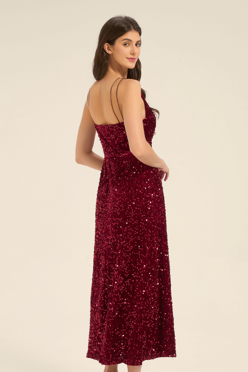 Side view of a burgundy sequin maxi dress with a fitted bodice, shimmering sequins, and double spaghetti straps.