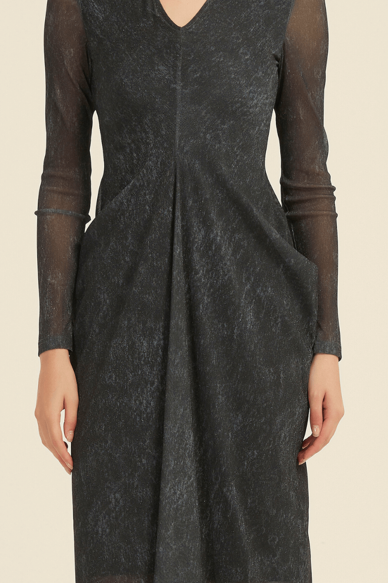 Close-up of a black sheer long sleeve midi dress showing textured fabric, soft pleats at the front, and a semi-transparent overlay.