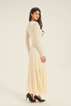 Back view of cream lace long-sleeve maxi dress, displaying the delicate lace texture and slim waist fit.