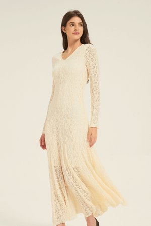 Close-up of cream lace long-sleeve maxi dress, highlighting the textured lace fabric and fitted silhouette.