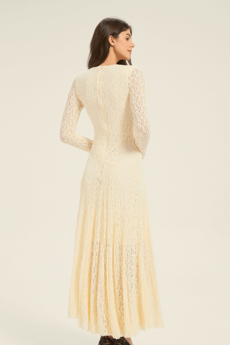 Full-length front view of cream lace long-sleeve maxi dress with flared hemline and feminine V-neck design.
