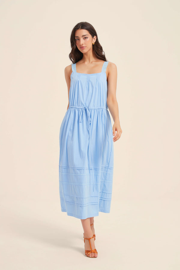 Front view of light blue sleeveless midi dress with wide straps and pintuck detailing, featuring a drawstring waist and relaxed A-line silhouette.