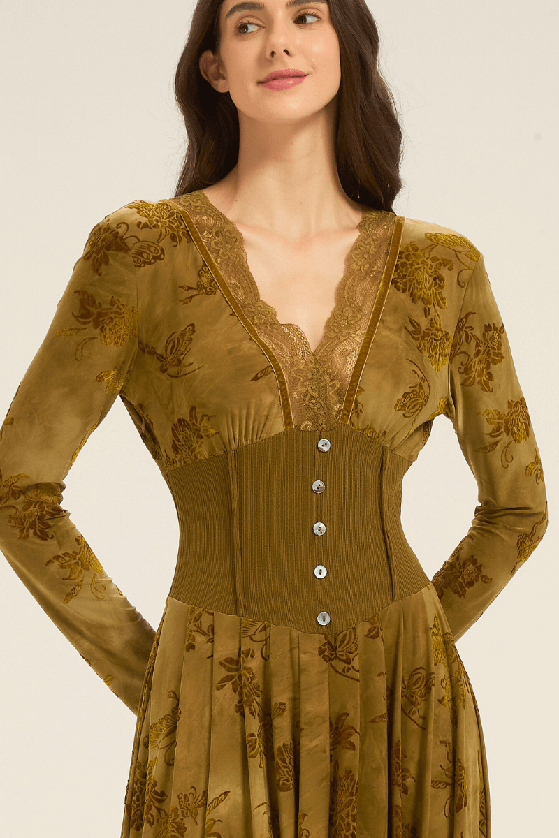 Close-up of olive green lace-trim maxi dress showing V-neckline with lace edging and buttoned corset-style waist.