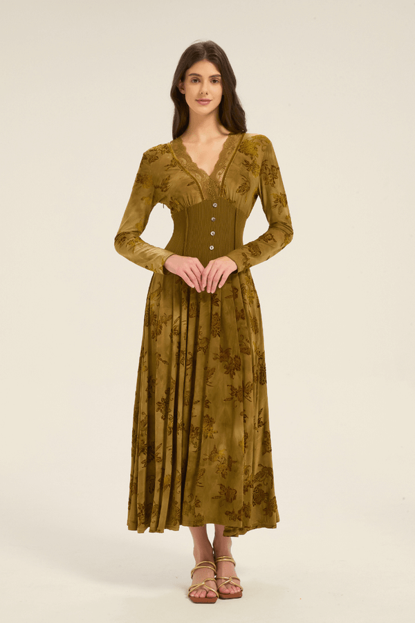 Front view of an olive green floral lace-trim maxi dress with long sleeves, buttoned waist, and flowing hem.