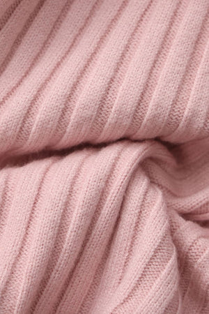 Close-up of a soft pink ribbed knit sweater fabric showing its cozy texture and fine stitching, highlighting the material used for Sioéne’s ruffled pink knit top.