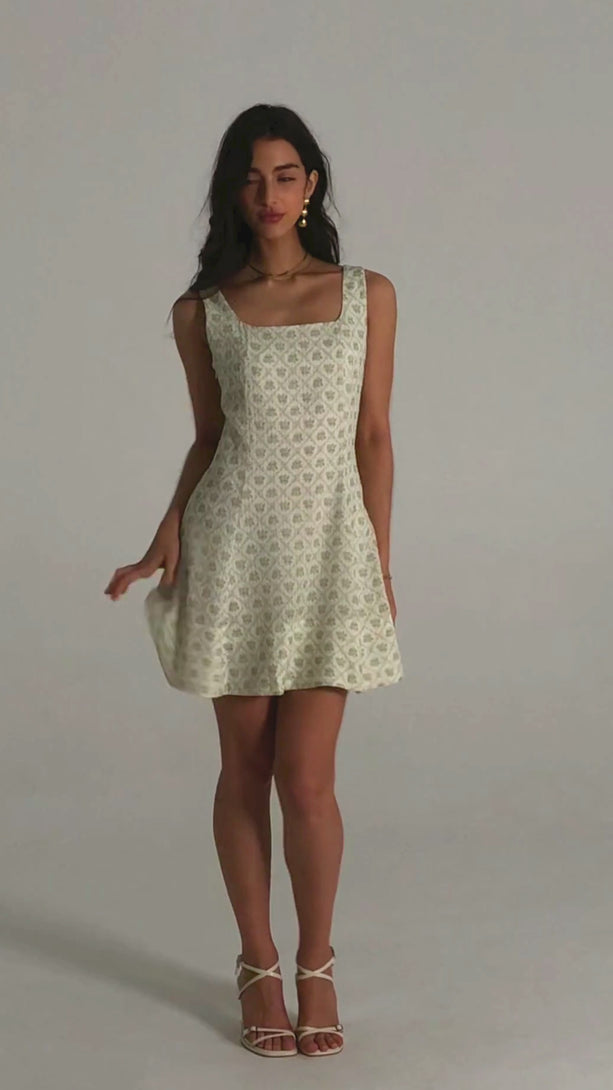 Sleeveless green floral mini dress with a soft flared hem and square neckline