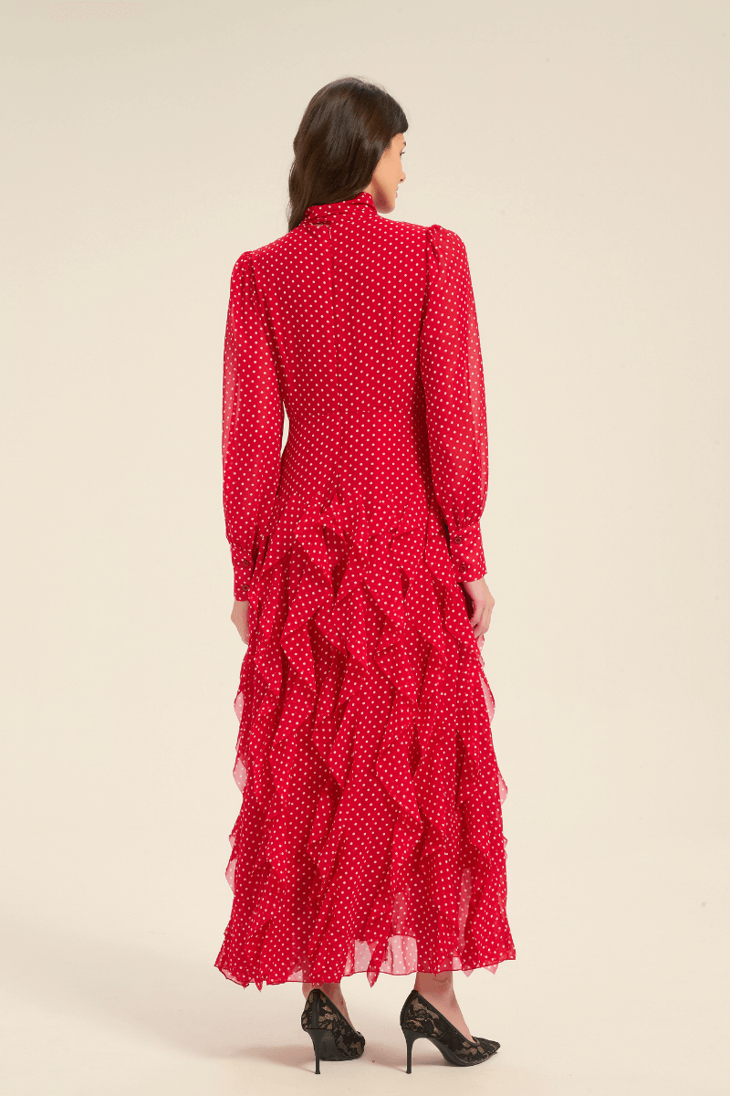 Back view of red polka dot midi dress with tiered ruffle skirt and long sleeves.