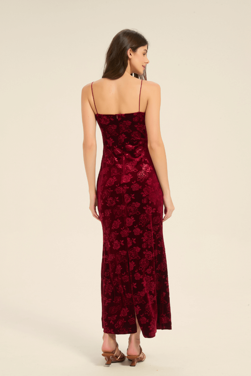 Back view of red velvet slip dress featuring slim straps and rose embossed design.