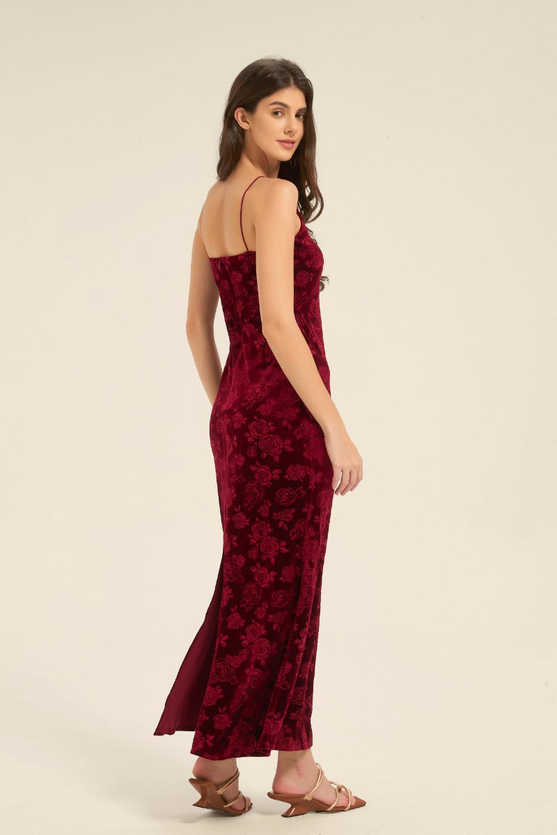 Side view of red velvet slip dress with delicate rose motifs and thin straps.