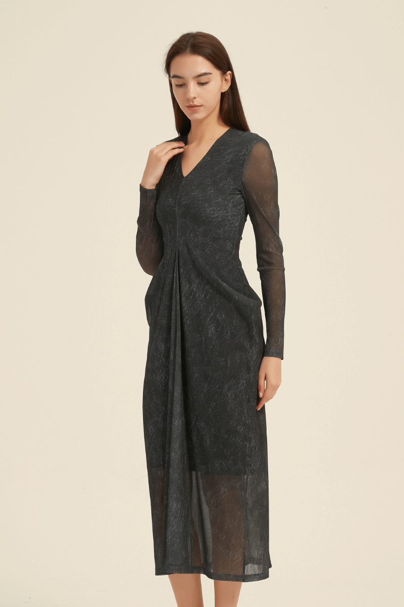 Side view of a black sheer long sleeve midi dress with a V-neckline, featuring a subtle pleated front and semi-transparent hem.
