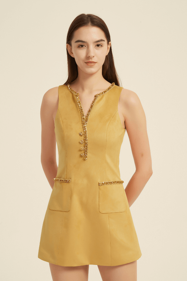 Front view of a sleeveless yellow mini dress featuring a V-neckline with beaded trim, decorative front buttons, and flap pockets with matching beaded accents.