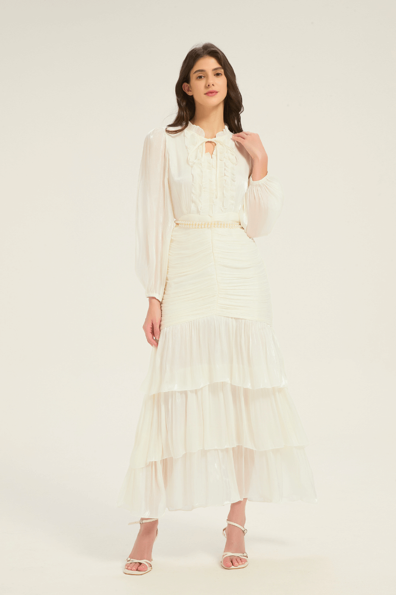 Front view of the white ruffle tiered midi dress with pearl belt, highlighting the ruffle neckline and tiered hemline.