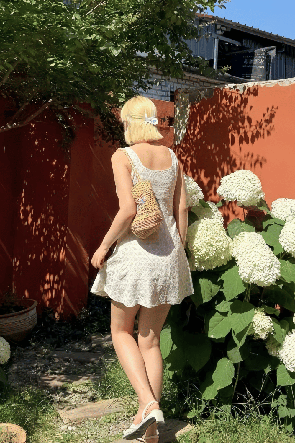 Woman wearing a light green floral sundress with a square neckline, perfect for summer and casual day outings
